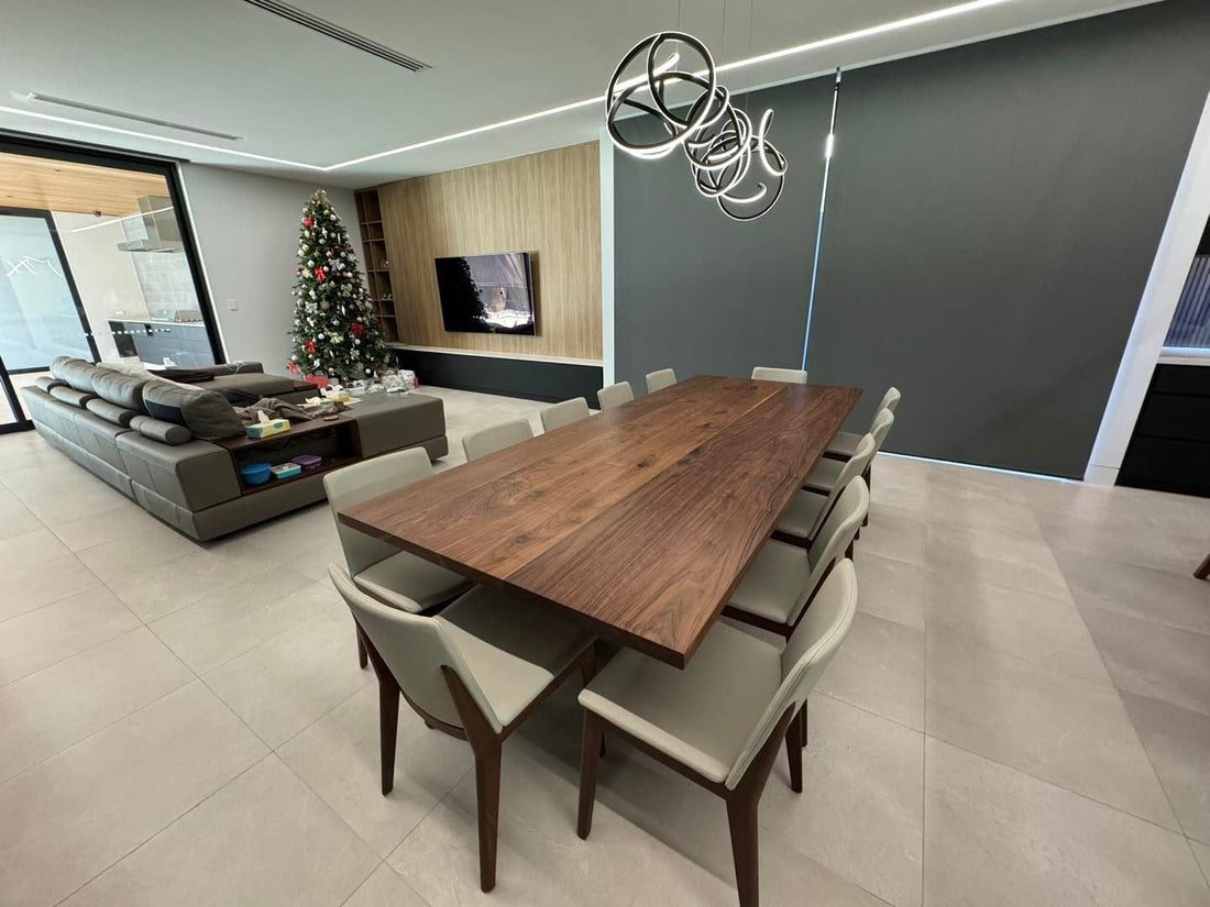 American Black Walnut dining table surrounded by upholstered chairs in a contemporary home
